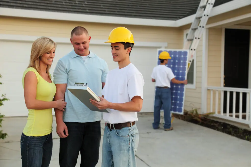 Homeowners getting solar panels installed on their house.